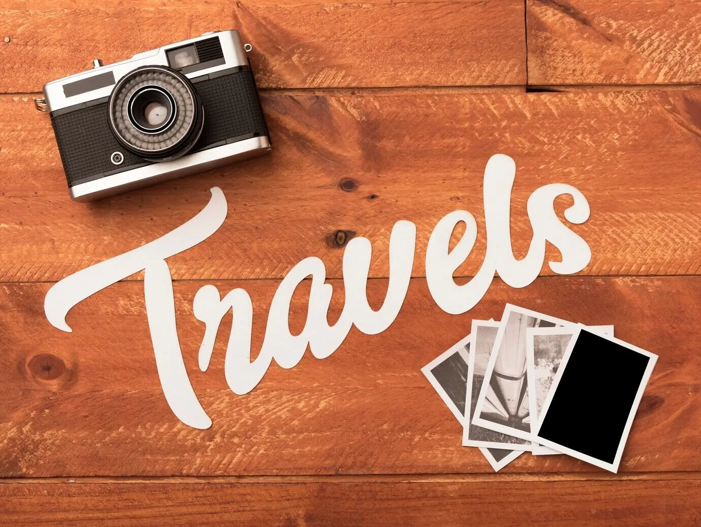 Reisefotos mit Kamera auf einem Holztisch